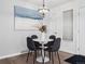 Cozy dining area with a round table, comfortable chairs, and a stylish light fixture at 6755 S Ivy St # A7, Centennial, CO 80112