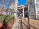 Exterior view of the building featuring stairs to the upper level and rock landscaping at 6755 S Ivy St # A7, Centennial, CO 80112