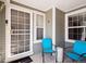 Charming front porch area with two blue chairs and a decorative side table at 6755 S Ivy St # A7, Centennial, CO 80112