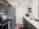 Kitchen featuring black cabinets, stainless steel appliances, and white quartz countertops at 6755 S Ivy St # A7, Centennial, CO 80112