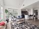 Open-concept living room with a view into a kitchen and a large indoor plant at 6755 S Ivy St # A7, Centennial, CO 80112