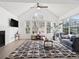 Bright living room with vaulted ceilings, large windows, and a modern patterned rug at 6755 S Ivy St # A7, Centennial, CO 80112