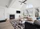 Living room with a fireplace, high ceilings and many windows letting in natural light at 6755 S Ivy St # A7, Centennial, CO 80112