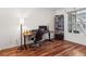 Home office featuring a modern desk, an ergonomic chair, and a bookshelf near a bright window at 6755 S Ivy St # A7, Centennial, CO 80112