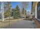 Private patio area surrounded by mature trees and a fenced backyard at 9256 W Euclid Ave, Littleton, CO 80123
