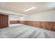 Finished basement with wood paneled walls and carpet flooring at 9256 W Euclid Ave, Littleton, CO 80123
