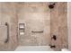 Tiled tub and shower in updated bathroom at 9256 W Euclid Ave, Littleton, CO 80123