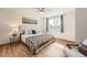 Bright bedroom with hardwood floors, ceiling fan, and natural light from the window at 9256 W Euclid Ave, Littleton, CO 80123