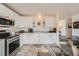Well-lit kitchen featuring stainless steel appliances and easy access to dining area at 9256 W Euclid Ave, Littleton, CO 80123