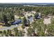 Aerial view of home surrounded by lush forest, with a long driveway, showcasing privacy at 347 S White Tail Dr, Franktown, CO 80116