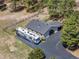 Aerial view of home with a circular driveway, recreational vehicle, and lush tree coverage at 347 S White Tail Dr, Franktown, CO 80116