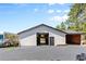 Exterior of the barn featuring a large door and attached open storage at 347 S White Tail Dr, Franktown, CO 80116