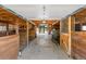 Interior view of the barn with wood framing, concrete floor, and an open layout to outside at 347 S White Tail Dr, Franktown, CO 80116