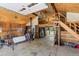 Interior view of the barn showing a wood interior, storage, and staircase to a loft area at 347 S White Tail Dr, Franktown, CO 80116