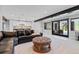 Finished basement features a wet bar, tile floors, a leather sofa and walk-out patio doors at 347 S White Tail Dr, Franktown, CO 80116