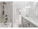Charming bathroom featuring a tiled shower, marble floors, and double vanity at 347 S White Tail Dr, Franktown, CO 80116