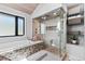 Bright bathroom features a soaking tub and large glass-enclosed shower with tile surround and wood ceiling at 347 S White Tail Dr, Franktown, CO 80116