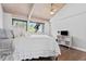 Bright bedroom features hardwood floors, a ceiling fan and scenic backyard views from a large window at 347 S White Tail Dr, Franktown, CO 80116