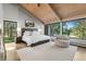 Serene bedroom with large windows, vaulted ceilings, and a cozy seating area at 347 S White Tail Dr, Franktown, CO 80116