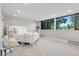 Bright bedroom features large windows with forest views, soft carpet and light gray walls at 347 S White Tail Dr, Franktown, CO 80116