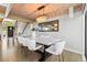 Elegant dining room with a marble table, seating for eight, and modern lighting at 347 S White Tail Dr, Franktown, CO 80116