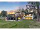 Back exterior of home featuring a large deck, stairs to the backyard, and large windows at 347 S White Tail Dr, Franktown, CO 80116