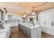 Contemporary kitchen featuring an oversized island, wood ceiling beams, and stylish lighting, offering a luxurious cooking experience at 347 S White Tail Dr, Franktown, CO 80116