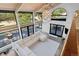 Bright living room with vaulted ceilings, floor-to-ceiling windows, and access to an outdoor deck, perfect for entertaining at 347 S White Tail Dr, Franktown, CO 80116