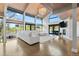 Spacious living room featuring a stone fireplace, vaulted ceilings, and large windows offering scenic outdoor views, perfect for relaxing at 347 S White Tail Dr, Franktown, CO 80116