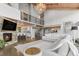 Open-concept living room with stone fireplace, vaulted ceilings, and an upper-level loft, creating a cozy and spacious atmosphere at 347 S White Tail Dr, Franktown, CO 80116