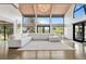 Expansive living room with vaulted ceilings, large windows, and a stylish white sofa, creating a bright and airy space at 347 S White Tail Dr, Franktown, CO 80116