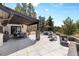 Expansive outdoor living space with covered patio, dining area, and ample seating at 347 S White Tail Dr, Franktown, CO 80116