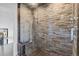 Nicely tiled shower features a seat, rainfall shower head and glass door at 347 S White Tail Dr, Franktown, CO 80116
