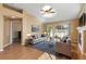 Spacious living room with hardwood floors, fireplace, a ceiling fan, and sliding door access at 13535 W 62Nd Ln, Arvada, CO 80004