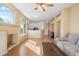 Open concept living room featuring a fireplace, hardwood floors, natural light, and an eat-in kitchen at 13535 W 62Nd Ln, Arvada, CO 80004