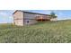 Backyard leading up to two story home with walk out deck at 11100 Haskell Creek Rd, Larkspur, CO 80118