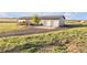 Backyard view of home with deck and two car garage on grassy lot at 11100 Haskell Creek Rd, Larkspur, CO 80118
