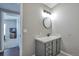 Clean bathroom with a vanity, round mirror and shower/tub combo at 11100 Haskell Creek Rd, Larkspur, CO 80118