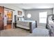 Bedroom with a view of the bathroom and a sliding barn door at 11100 Haskell Creek Rd, Larkspur, CO 80118