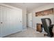 Bedroom with carpet, closet, desk, and art hanging on the wall at 11100 Haskell Creek Rd, Larkspur, CO 80118