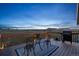 Deck with outdoor seating, grill, and beautiful sunset view at 11100 Haskell Creek Rd, Larkspur, CO 80118