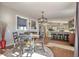 Bright dining room with a table, chairs, and an open kitchen concept at 11100 Haskell Creek Rd, Larkspur, CO 80118