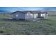 Gray two story home with lawn at dusk at 11100 Haskell Creek Rd, Larkspur, CO 80118