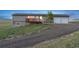 Gray single-story house with deck and lawn at 11100 Haskell Creek Rd, Larkspur, CO 80118