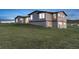 Gray two-story house with lawn and blue sky at 11100 Haskell Creek Rd, Larkspur, CO 80118