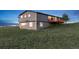 Rear view of gray two-story house with walkout basement and deck at 11100 Haskell Creek Rd, Larkspur, CO 80118