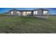 Gray single-story house with green lawn at dusk at 11100 Haskell Creek Rd, Larkspur, CO 80118
