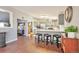 Bright kitchen features gray cabinets, stainless appliances, and three stools at the breakfast bar at 11100 Haskell Creek Rd, Larkspur, CO 80118