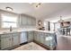Bright kitchen with gray cabinets, stainless appliances and an island at 11100 Haskell Creek Rd, Larkspur, CO 80118