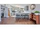 Modern kitchen with gray cabinets, island with seating, and stainless steel appliances at 11100 Haskell Creek Rd, Larkspur, CO 80118